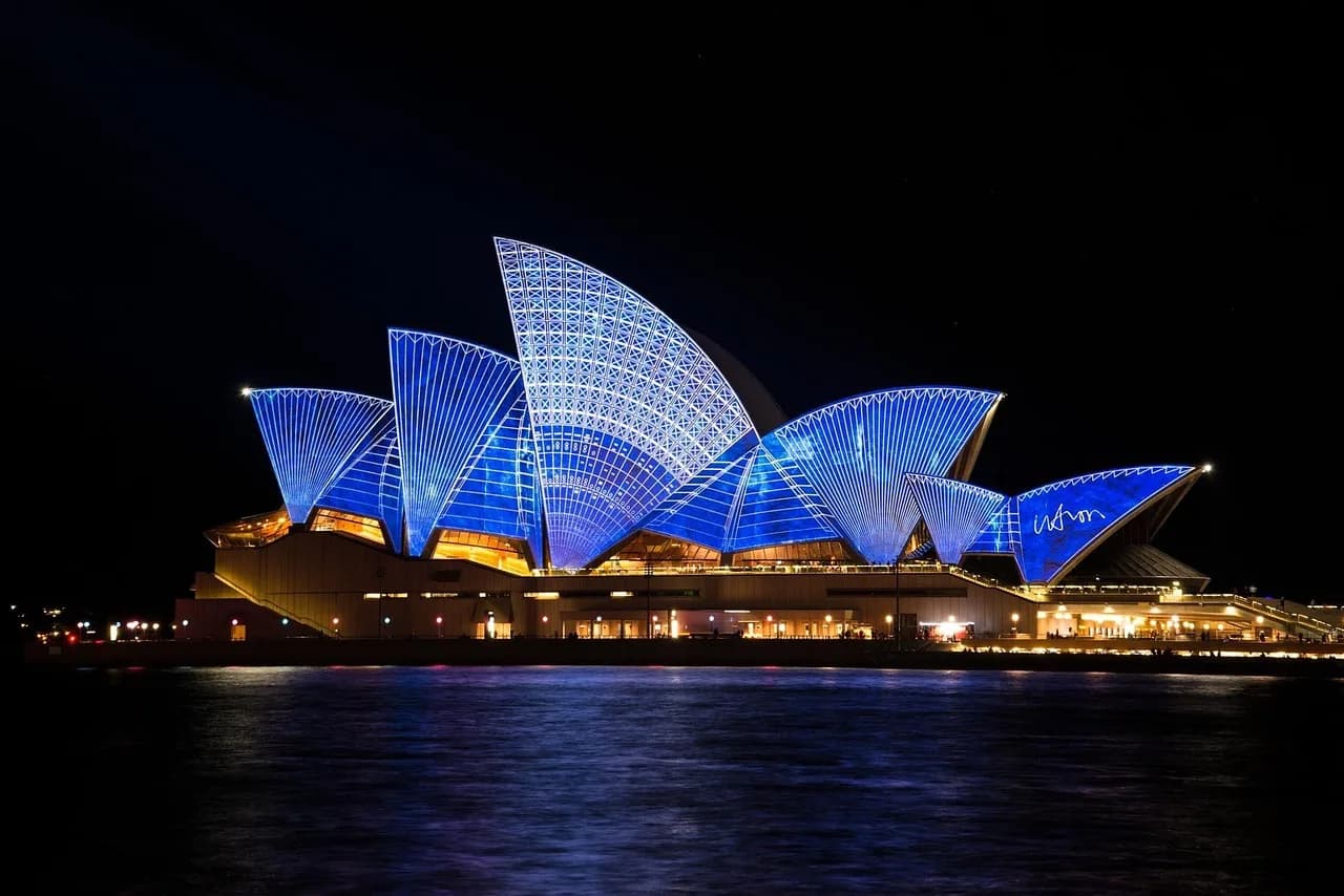 sydney opera house, building, architecture, illuminated, famous, tourist attraction, landmark, lightings, light show, night, evening, performing arts center, sydney harbour, port jackson, sydney, new
